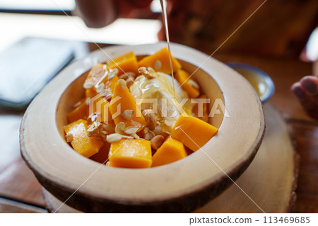Mango yogurt on the table in a dessert shop 113469685