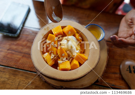 Mango yogurt on the table in a dessert shop 113469686