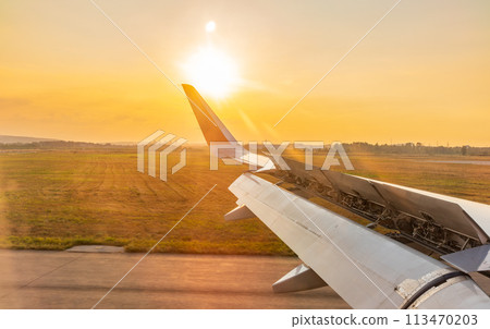 View on sunset and airplane wing from the inside View on sunset and airplane wing from the inside 113470203