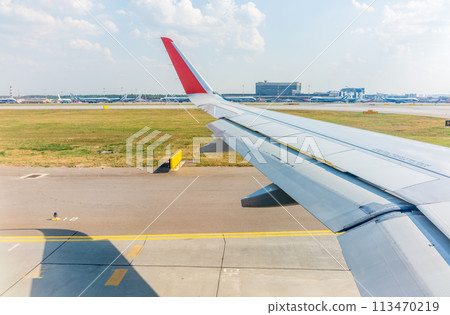 View from the airplane window during takeoff at Sheremetyevo airport at summer View from the airplane window during takeoff at Sheremetyevo airport at summer 113470219