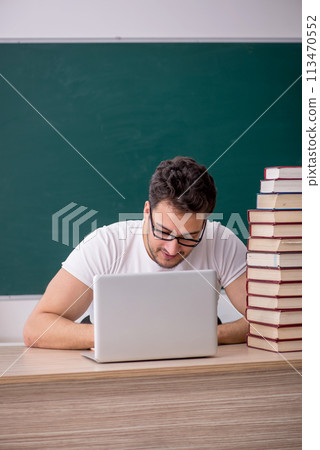 Young male student sitting in the classroom 113470552