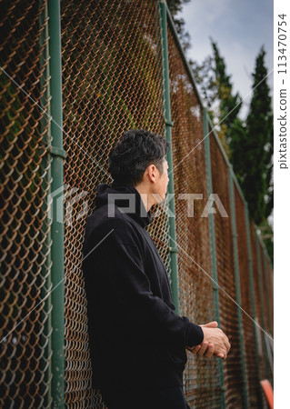 A man waiting for someone outside A man waiting for someone outside 113470754