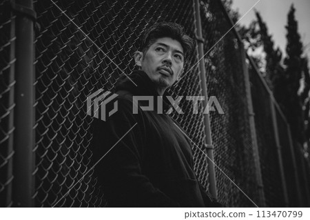 A man waiting for someone outside 113470799