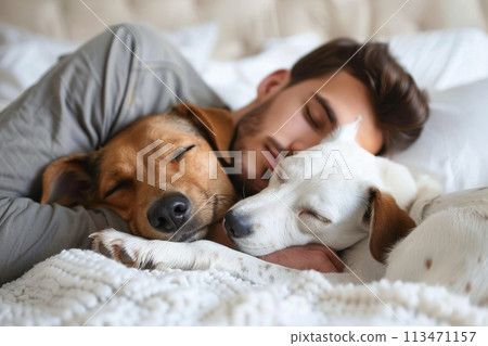 A man is sleeping with his dog on a bed 113471157