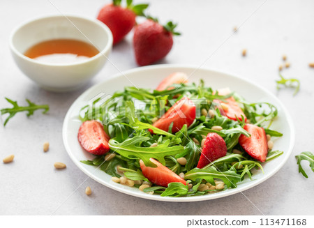 Fresh Strawberry Arugula Salad With Pine Nuts Served on a Bright Day Fresh Strawberry Arugula Salad With Pine Nuts Served on a Bright Day 113471168