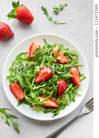 Fresh Strawberry Arugula Salad With Pine Nuts Served on a Bright Day Fresh Strawberry Arugula Salad With Pine Nuts Served on a Bright Day 113471169