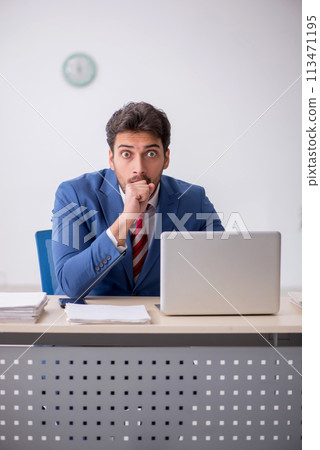Young male employee working in the office Young male employee working in the office 113471195