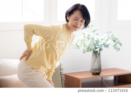 Lower back pain - middle-aged woman with lower back pain Lower back pain - middle-aged woman with lower back pain 113471916