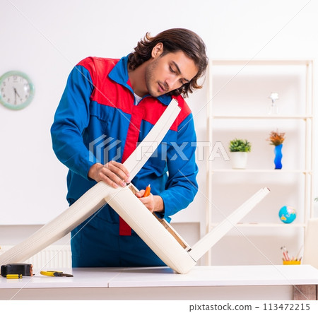 Young male carpenter working indoors Young male carpenter working indoors 113472215
