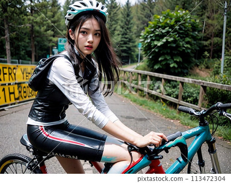 A young girl with long hair riding a bicycle 113472304