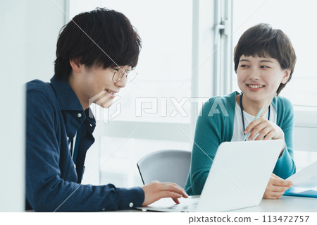 Young men and women working on computers Young men and women working on computers 113472757