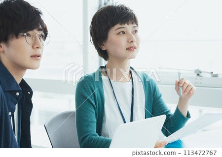 Young men and women working on computers 113472767