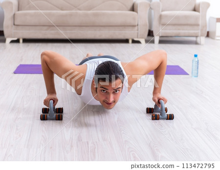Young man training and exercising at home Young man training and exercising at home 113472795