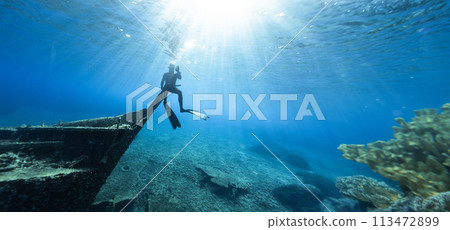 Freediver Sitting on Shipwreck in Shallow Sea With Sea Grass. 113472899