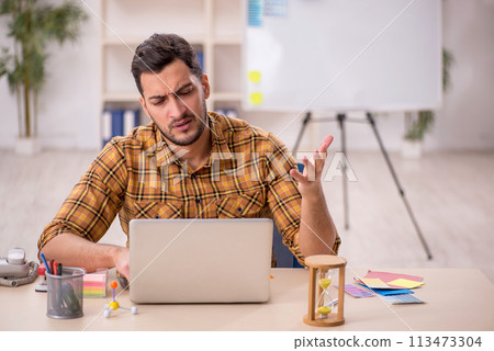 Young male designer working in the office Young male designer working in the office 113473304
