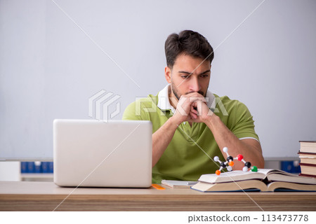 Young male student physicist sitting in the classroom Young male student physicist sitting in the classroom 113473778