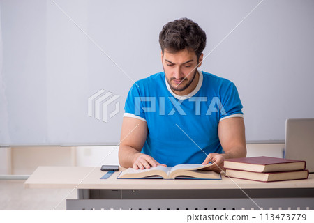 Young male student in front of whiteboard Young male student in front of whiteboard 113473779