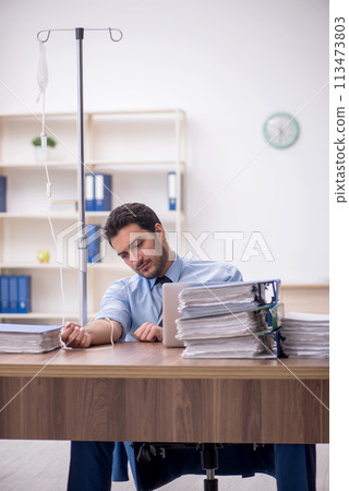 Young male employee suffering at workplace 113473803