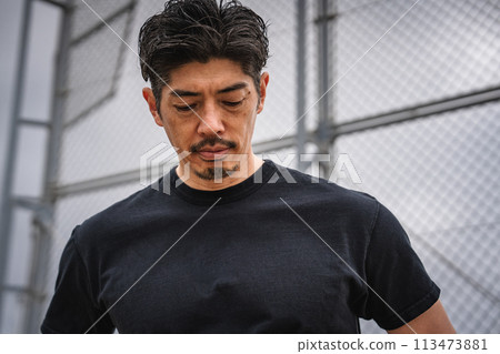 A man in his 40s taking a break during outdoor training A man in his 40s taking a break during outdoor training 113473881