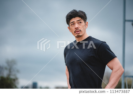 一名40多歲的男子在戶外訓練時休息 113473887
