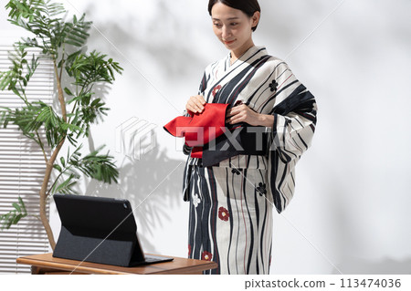 A woman wearing a yukata A woman wearing a yukata 113474036