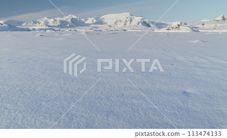 Panorama of scientific base in Infinitely, Infinitely polar snowy Antarctica desert. South Pole frost surface. Snow covered mountains on horizon. Aerial view flight. Ice Landscape. Winter frozen 113474133