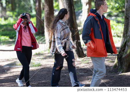 Group of young friends Walking Through a Forest Group of young friends Walking Through a Forest 113474453