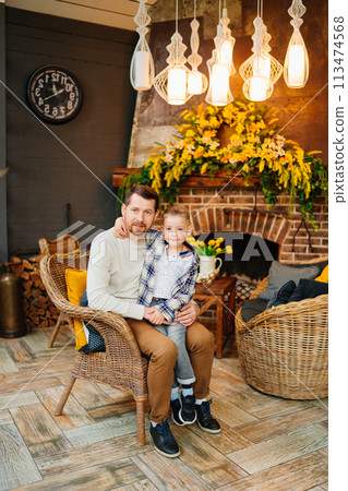 Dad with little son in retro style country house room.  113474568