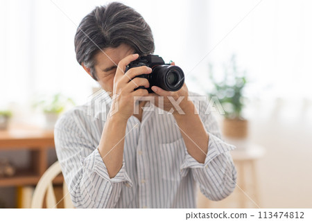 A man enjoying his hobby of photography A man enjoying his hobby of photography 113474812
