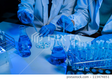 Science and medicine, scientist analyzing and dropping a sample into a glassware, experiments containing chemical liquid in laboratory on glassware, innovative and technology. 113474851