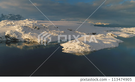 Drone view above Antarctic polar station - Vernadsky Base. Ocean coast - open water surface. Snow covered south pole settlement. Majestic landscape aerial flight Drone view above Antarctic polar station - Vernadsky Base. Ocean coast - open water surface. Snow covered south pole settlement. Majestic landscape aerial flight 113474905