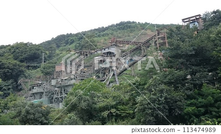 A huge construction site in the mountains A huge construction site in the mountains 113474989