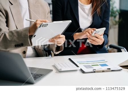 Businessman and team analyzing financial statement Finance task. with smart phone and laptop and tablet. Wealth management concept. Businessman and team analyzing financial statement Finance task. with smart phone and laptop and tablet. Wealth management concept. 113475329