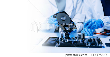 Technician repairing inside of hard disk drive by screwdriver. the concept of data, hardware, technician and technology. computer hardware, upgrade . Technician repairing inside of hard disk drive by screwdriver. the concept of data, hardware, technician and technology. computer hardware, upgrade . 113475364