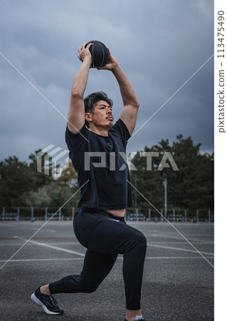 A man in his 40s doing strength training outdoors A man in his 40s doing strength training outdoors 113475490