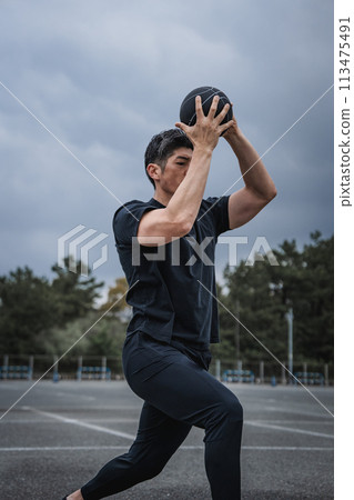 A man in his 40s doing strength training outdoors A man in his 40s doing strength training outdoors 113475491