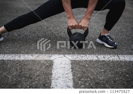 A man in his 40s doing strength training outdoors A man in his 40s doing strength training outdoors 113475827