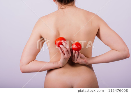 Female with tomatoes on her chest and back, concept of healthy food and female health 113476008