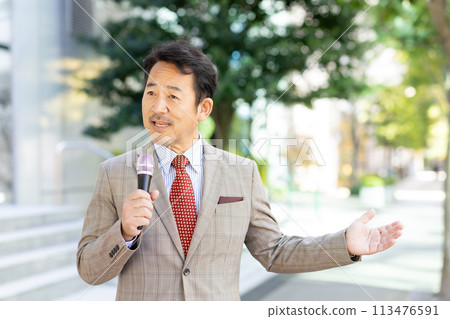 man giving a speech on the street 113476591