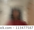 Woman reflected in a foggy mirror in the bathroom 113477587