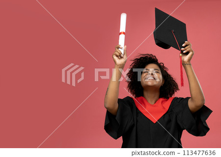A young African American woman in a graduation uniform 113477636