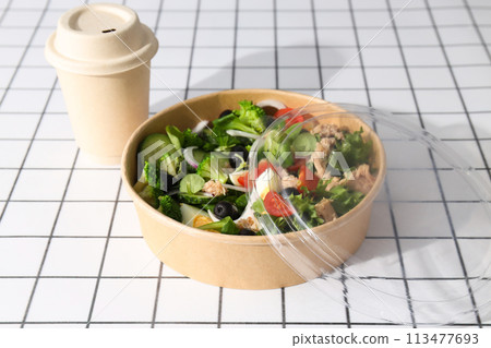Tuna salad in a cardboard plate on a light table. 113477693