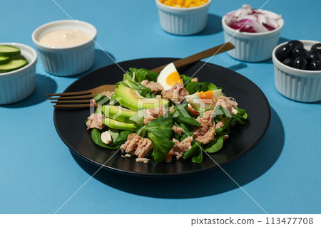 Salad with tuna on a blue background. 113477708