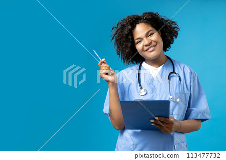 A young African American woman in a doctor's uniform 113477732
