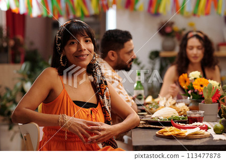 Young woman sitting by served table Young woman sitting by served table 113477878