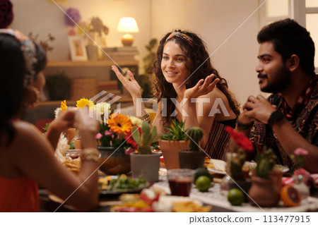 Happy woman chatting to one of guests 113477915