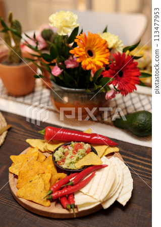 Appetizing snacks on wooden board Appetizing snacks on wooden board 113477953