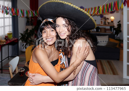 Two happy girl enjoying home party Two happy girl enjoying home party 113477965