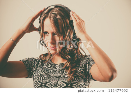 woman in headphones listening music mp3 relaxing 113477992