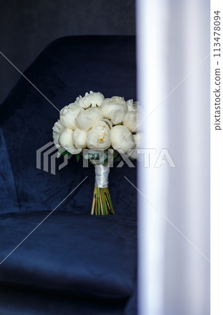 Bride's bouquet of white peonies with wedding rings Bride's bouquet of white peonies with wedding rings 113478094
